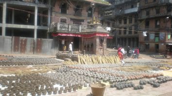 Rows of clay pots drying in Bhaktapur Pottery Square.