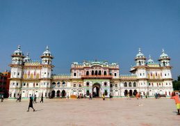 White Janaki Mandir façade and towers beneath a blue sky.