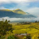 Terraced fields and Khokana settlement beneath misty hills.