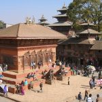 Brick temple and visitors in Kathmandu Durbar Square.