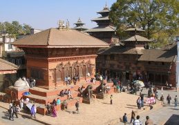 Brick temple and visitors in Kathmandu Durbar Square.