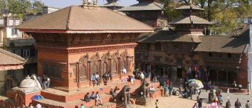 Brick temple and visitors in Kathmandu Durbar Square.
