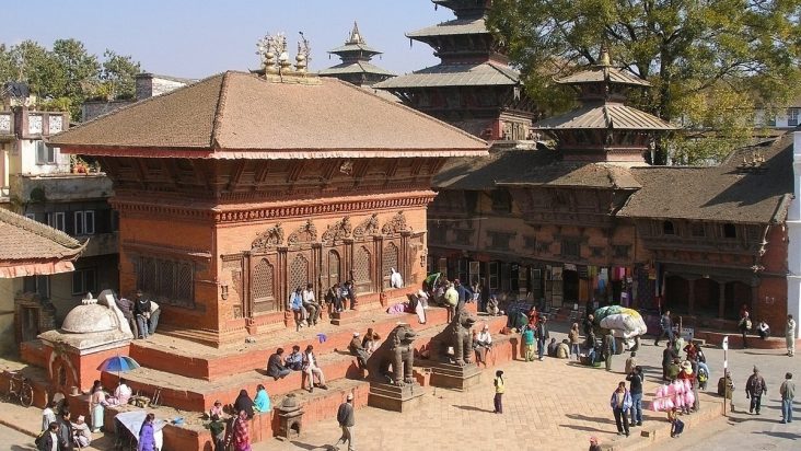 Brick temple and visitors in Kathmandu Durbar Square.