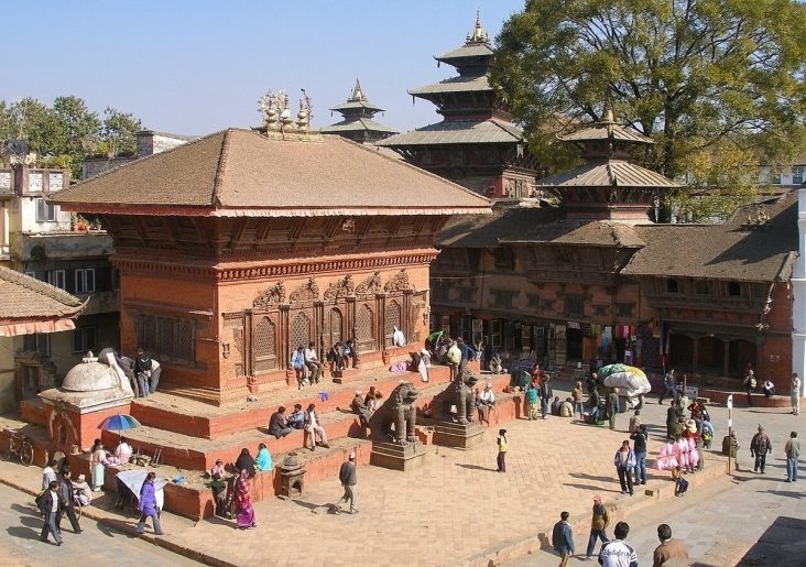 Brick temple and visitors in Kathmandu Durbar Square.