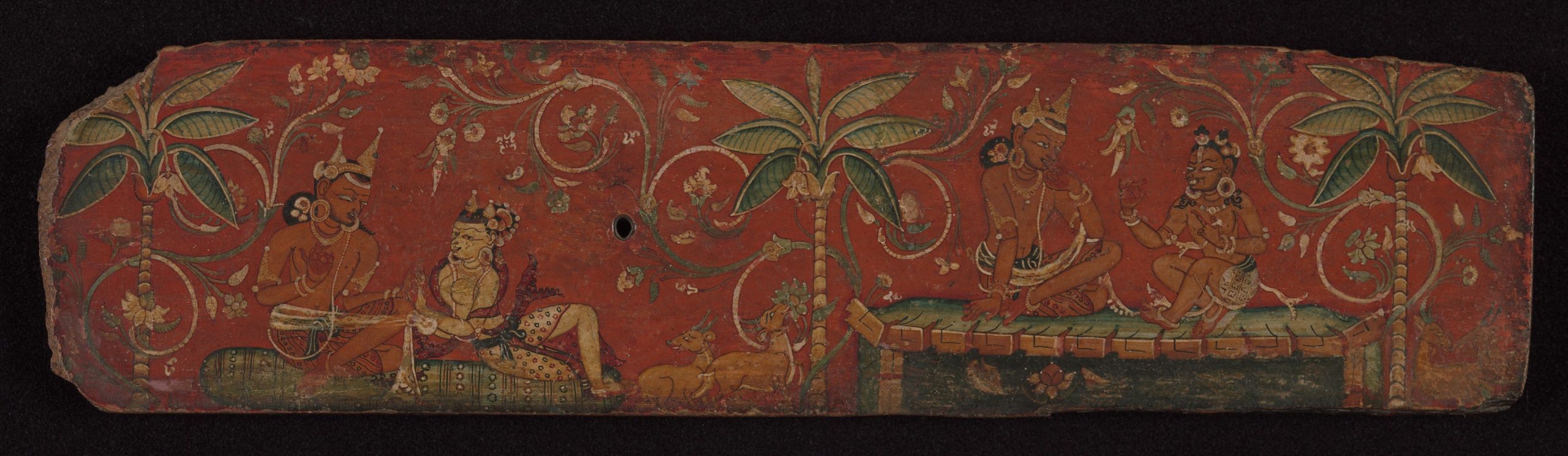 A long painted Nepali manuscript cover with figures and trees against a red background.