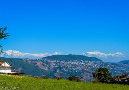 Tansen town on wooded hills with the Himalayan range behind.