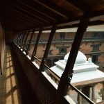 Brick courtyard and carved timber galleries at Patan Museum.