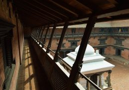Brick courtyard and carved timber galleries at Patan Museum.