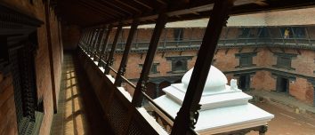 Brick courtyard and carved timber galleries at Patan Museum.