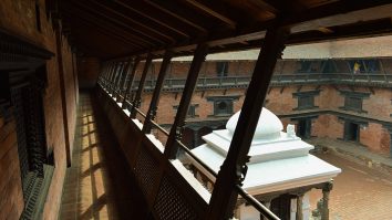 Brick courtyard and carved timber galleries at Patan Museum.