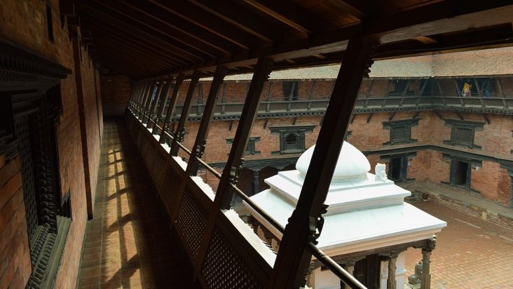 Brick courtyard and carved timber galleries at Patan Museum.
