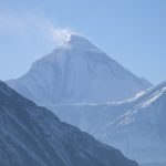 Snow-covered Dhaulagiri above dark Himalayan ridges.
