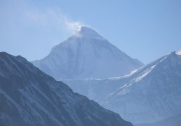 Snow-covered Dhaulagiri above dark Himalayan ridges.