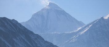 Snow-covered Dhaulagiri above dark Himalayan ridges.