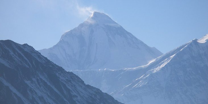 Snow-covered Dhaulagiri above dark Himalayan ridges.