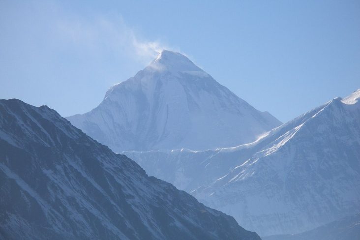 Snow-covered Dhaulagiri above dark Himalayan ridges.