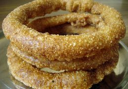 Golden rings of sel roti stacked together.