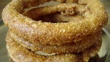 Golden rings of sel roti stacked together.