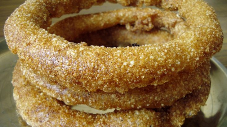 Golden rings of sel roti stacked together.