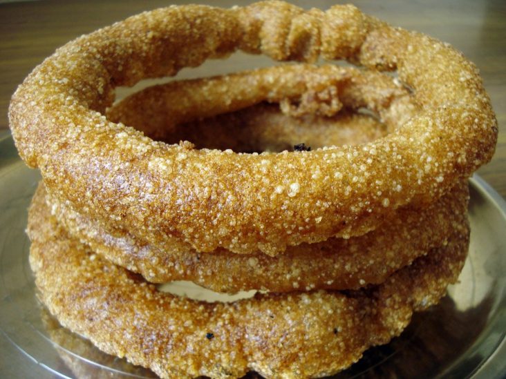 Golden rings of sel roti stacked together.